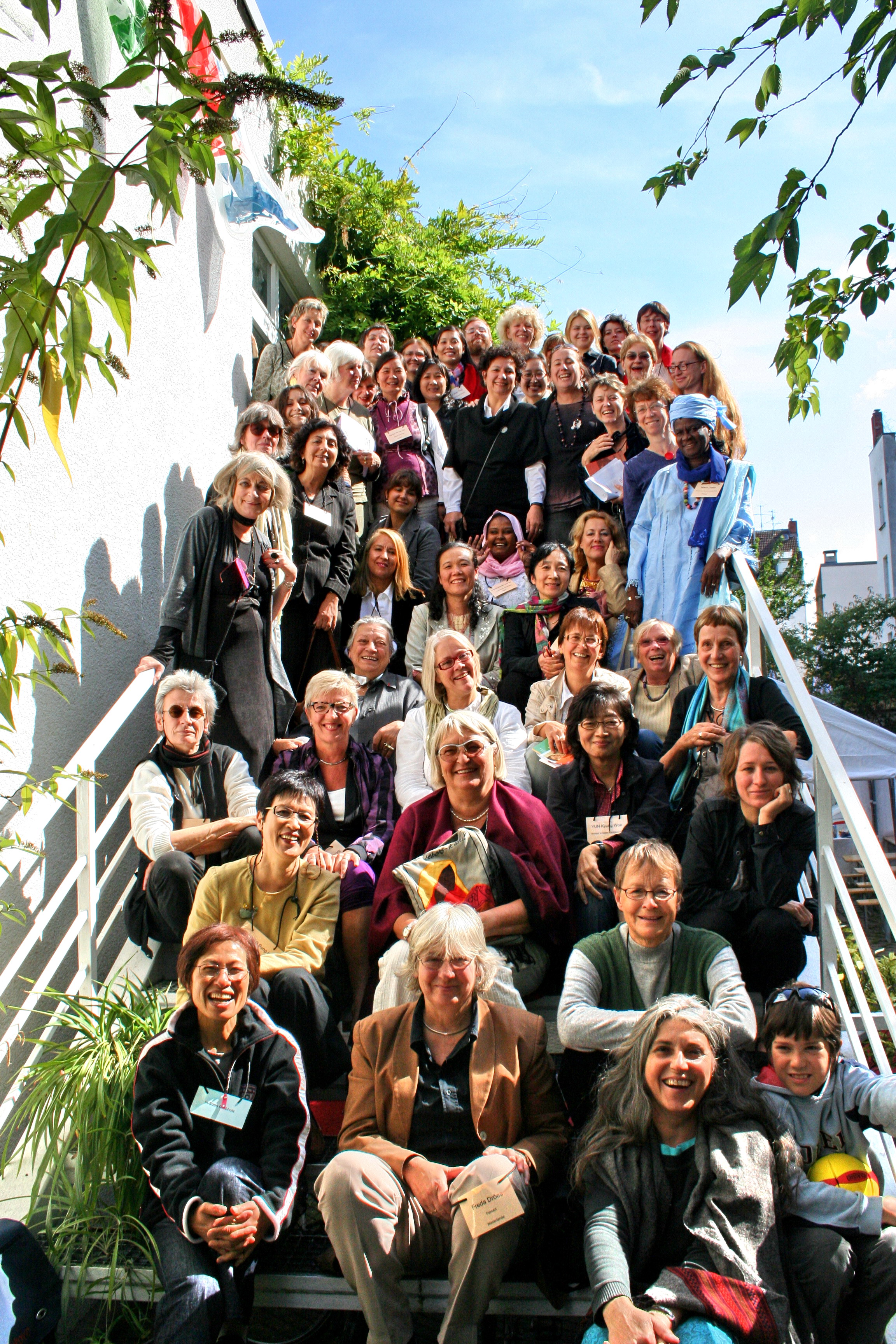 Participants of the 2009 conference assemble on the stairs as a group