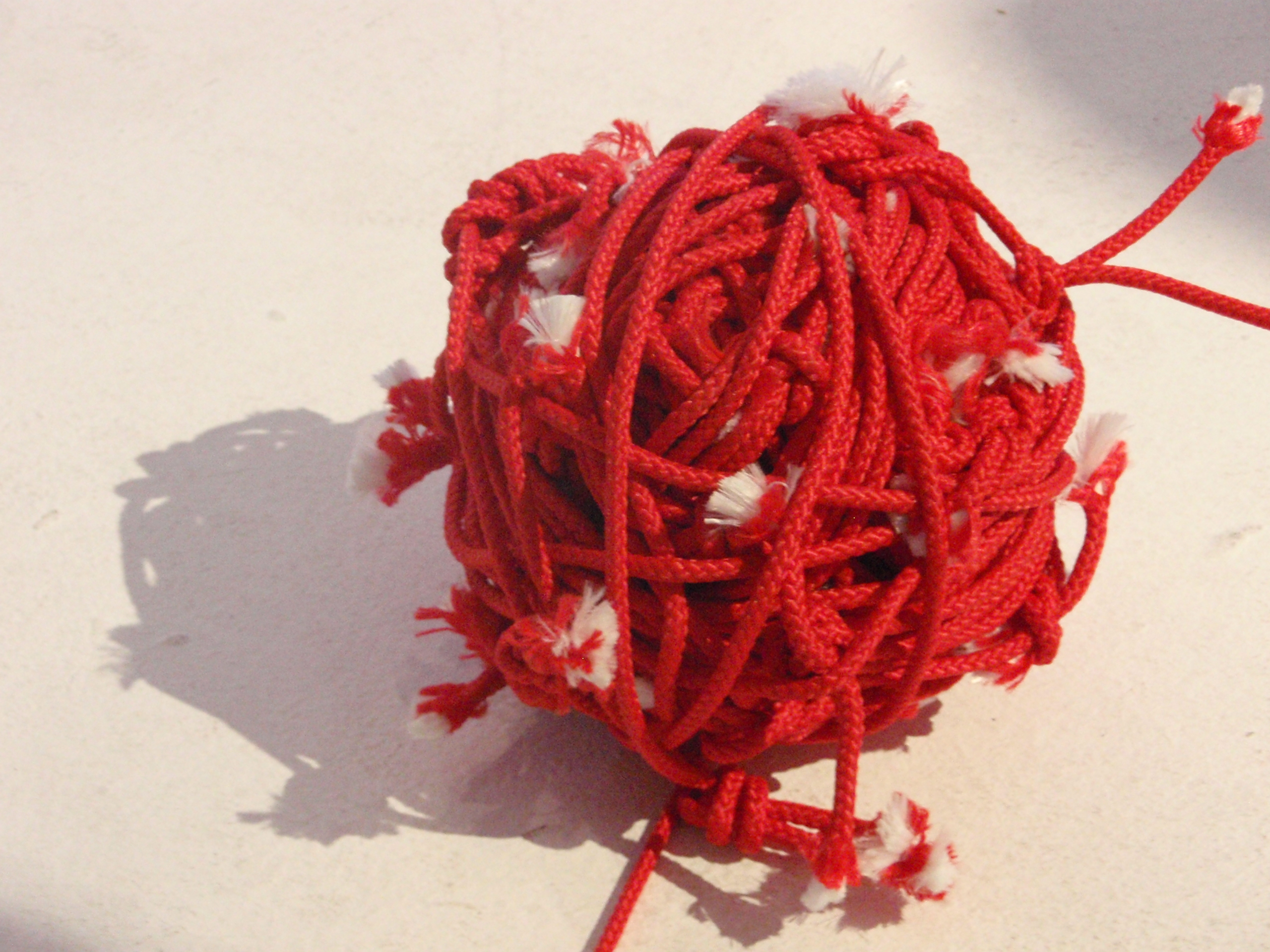 Red ball of tangled threads