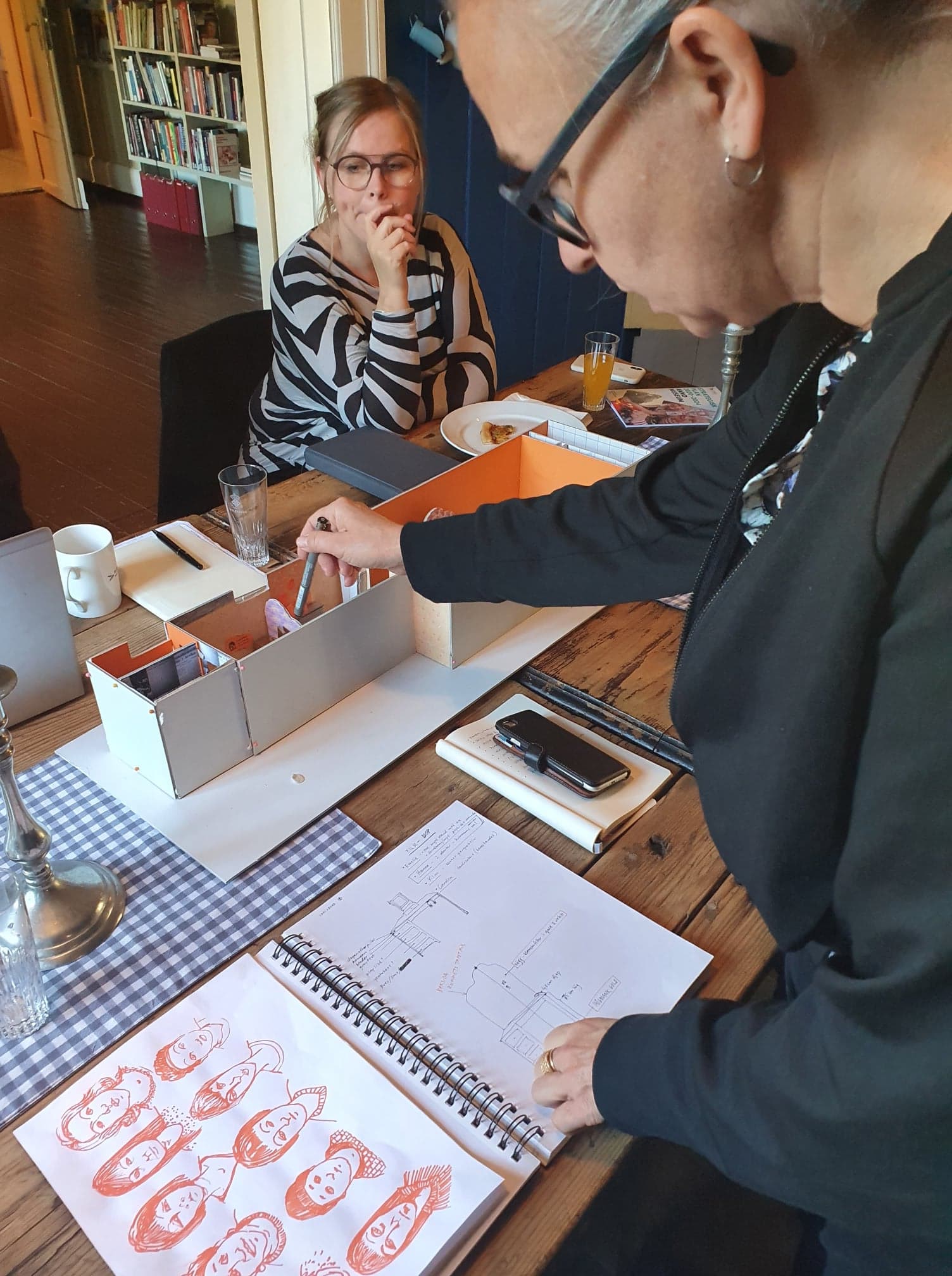 Helene Karlson shows the 3-D model made by the artist group OTALT to graphic designer Ellen Jacobsen.